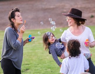 Families blowing bubbles