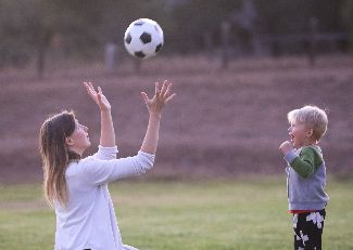 Mom playing ball with child